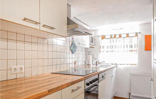 a kitchen with white appliances and a wooden counter top at Cozy Home In Mathon With House A Panoramic View in Mathon