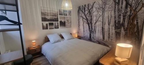 a bedroom with a bed with a black and white wall at La maison Saint-Gervais in Falaise