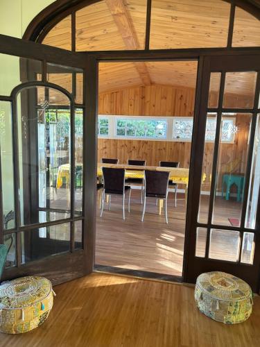 a room with glass doors and a table and chairs at Convent at Koroit in Koroit