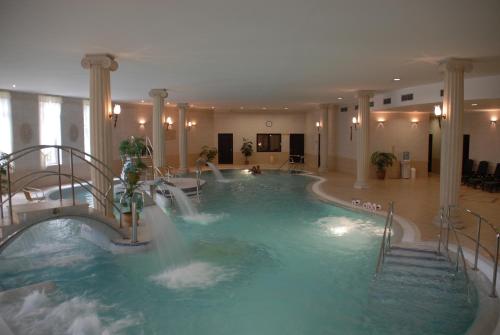 a swimming pool with a waterfall in a hotel at Bristol Georgy House in Karlovy Vary