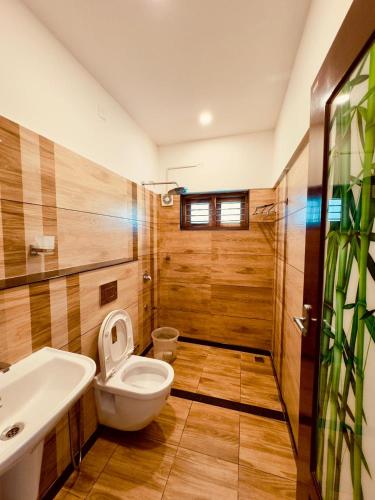 a bathroom with a toilet and a sink at Tea & Sky Munnar in Munnar