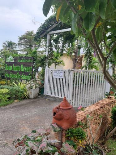 a flower pot sitting in a garden next to a fence at Baan innto resort in Fang