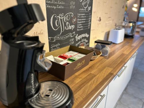 a coffee station with a box on a counter at Pension Hotel Leinefelde am Bahnhof in Leinefelde