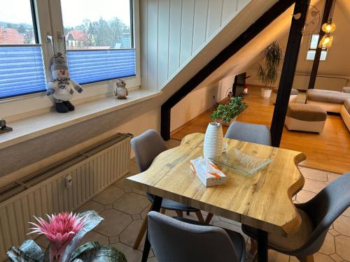 a dining room with a wooden table and chairs at Pension Hotel Leinefelde am Bahnhof in Leinefelde