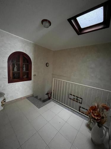 a large room with a window and a tile floor at Dimora dell'Etna in Randazzo