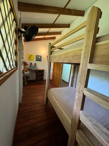 a bedroom with two bunk beds and a desk at Passion Fruit Lodge in Cahuita
