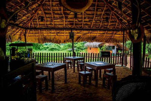 a group of tables and chairs in a tent at Animal View Point Yala in Tissamaharama