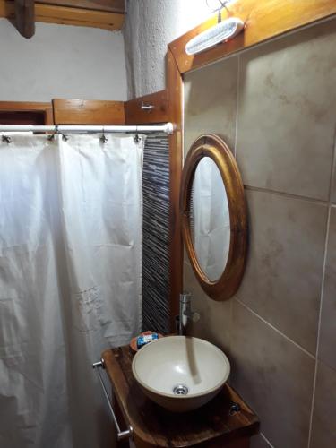 a bathroom with a sink and a mirror at El Camino in Villa Berna