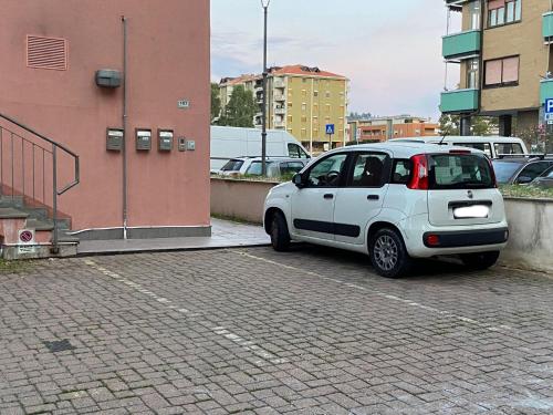 a white car parked in a parking lot at Right Bank House in Imperia