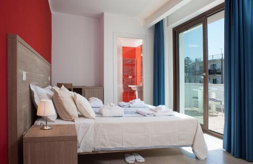 a bedroom with a bed and a large window at Hotel Villa Sveva in Cagliari