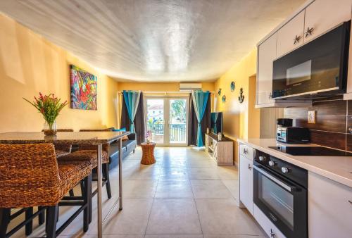 a kitchen with a table and a counter top at Apartment in downtown at the beach in Nassau