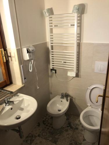 a small bathroom with a toilet and a sink at Moon River Guest House in Pescara