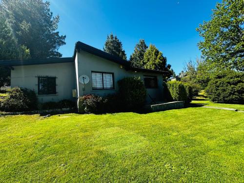 a house with a large lawn in front of it at Casa en Bariloche Familiar - R2046 in San Carlos de Bariloche