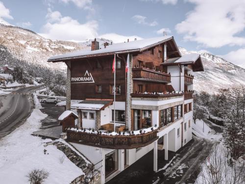 a hotel in the mountains in the snow at Boutique Hotel Panorama in Crans-Montana