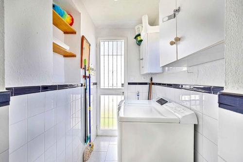 a white kitchen with a sink and a dishwasher at Villa Marite - 4 bed/ 2 bath - own private pool in Fuengirola