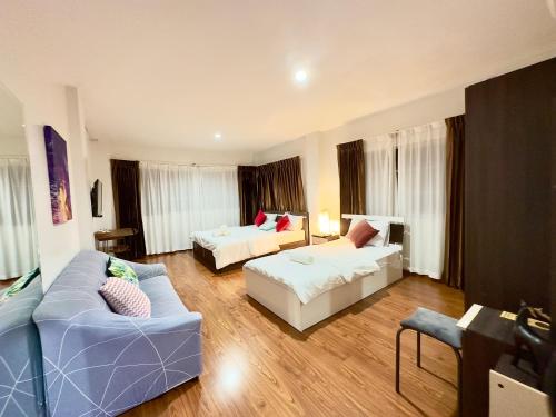 a living room with two beds and a couch at Comfy Boutique House in Chiang Mai