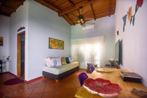 a living room with a bed and a table at Portoazul Casa de Playa in Puerto Colombia