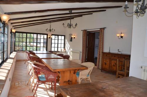 a dining room with a wooden table and chairs at Quinta de São Pedro in Sobreda