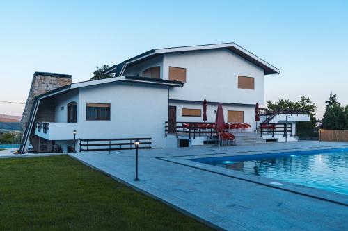 a house with a swimming pool in front of it at Casa de Férias da Costinha in Alijó
