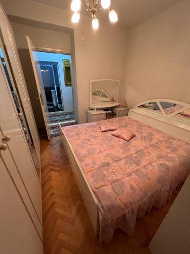 a bedroom with a bed and a mirror at Two luxury bedroom apartment D&V in Berovo