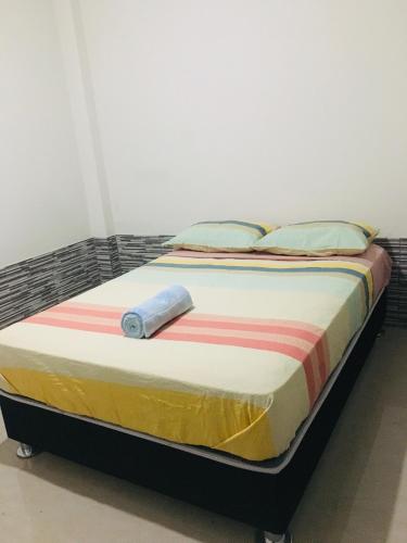 Una cama en una habitación con avertisementatronatronstrationstrationstrationstrationstrationstrationstrationstrationstration en Munaycha, en Tacna