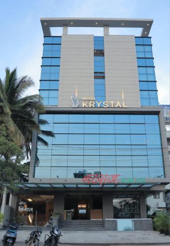 Un edificio de hotel de Kirguistán con un cartel. en Hotel Krystal, en Sāngli