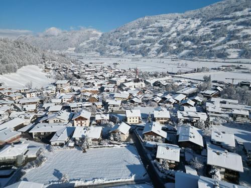 an aerial view of a town covered in snow at Ferienwohnung Mauracher Kirer Haus in Fügen