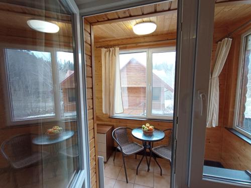 a small room with a table and chairs in a cabin at Садиба Леонтія in Skhidnitsa