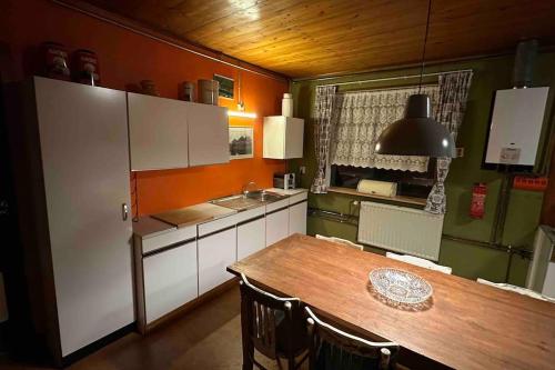a kitchen with a wooden table and a dining room at Beautiful farmhouse near Amsterdam center in Watergang