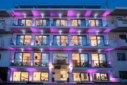 a large building with purple lights on it at Harma Boutique Hotel in Hersonissos
