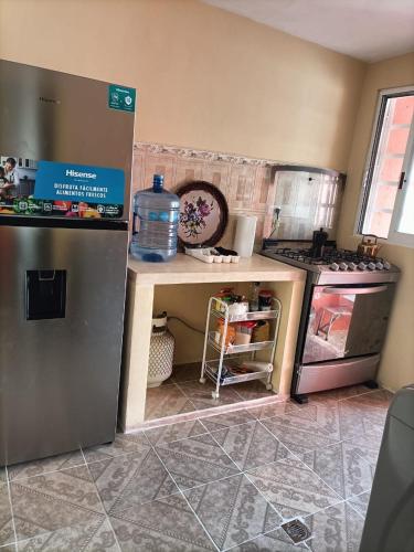 a kitchen with a counter with a water bottle on it at El Palacio Árabe in Mérida