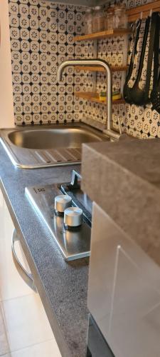 a kitchen with a sink and a counter with a counter at Residenza L'Archetto in Corona