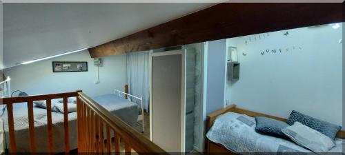 a room with a staircase and a room with a bed at Hameau du Rivage 224 - Rez de jardin climatisé - 3 étoiles - 6 Pers - Jardin - Piscine - Vélos prêtés - Parking - 400m de la plage de La Lagune - WIFI in Saint-Cyprien