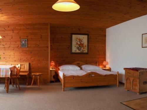 a bedroom with a bed in a wooden cabin at Haus Grafhube in Afritz-Verditz in Innere Einöde