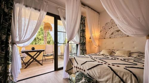 a bedroom with a bed and a balcony at The Green Hut - Costa Adeje in Adeje