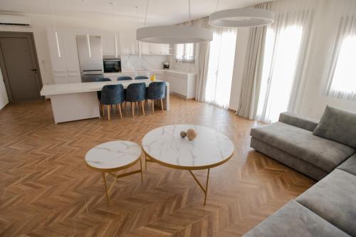 a living room with a couch and a table at Marble Luxury Suites in Karteros