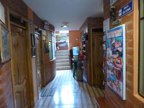 a hallway of a house with wooden floors and doors at Hostal La Casa Amarilla City in Baños