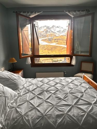 a bedroom with a bed and a large window at Formigal Valle del tena Rural Home in Formigal