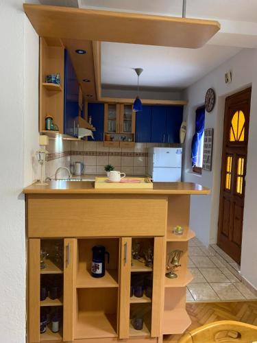 a kitchen with blue cabinets and a counter top at Garden Oasis Apartment in Veles