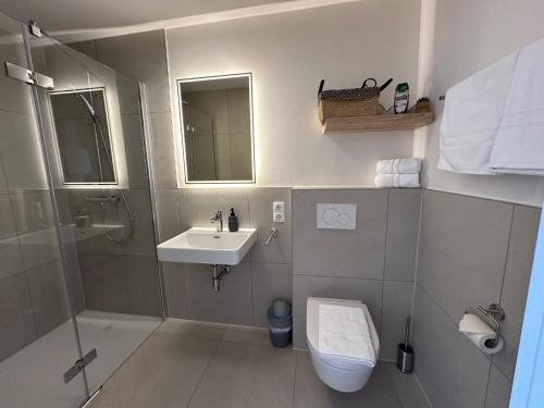 a bathroom with a toilet and a sink and a shower at Gasthof - Auszeit im Bad Diezlings - Adults only in Hörbranz