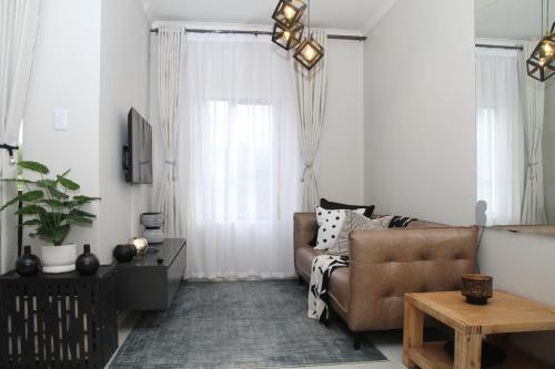 a living room with a couch and a table at Sublime - By LaSerene - Carlswald in Midrand