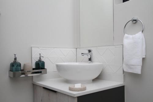 a white bathroom with a bowl sink on a counter at Sublime - By LaSerene - Carlswald in Midrand