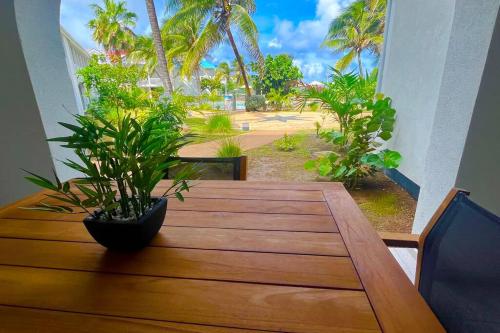 a dining room table with a view of a beach at orient bay studio -alamanda front de mer in Orient Bay