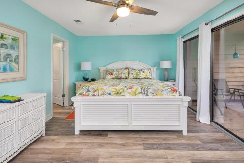 a bedroom with a bed and a ceiling fan at 274 Moss Oak Lane in Saint Simons Island