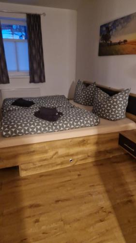 a large bed in a room with a wooden floor at Gemütliche Ferienwohnung in Elbingerode/Harz in Elbingerode