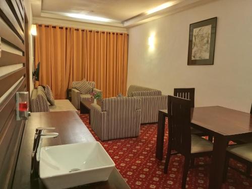 a living room with a couch and a table at Ramadia Ran Mal Holiday Resort in Moratuwa