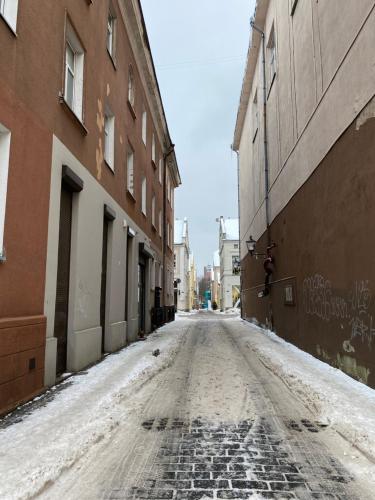 an empty street in an alley between buildings at Studio Apartment Old Town in Klaipėda