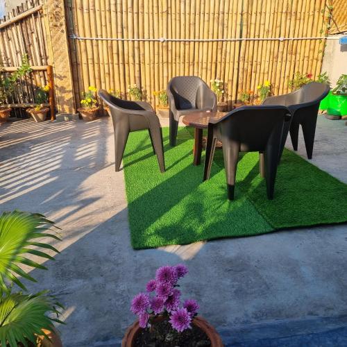 a group of chairs sitting on a patch of grass at Alohi The terrace Homestay in Tezpur