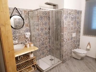 a bathroom with a shower and a sink and a toilet at Soffio Del Sud in Crispiano