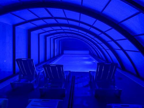 a blue tunnel with empty chairs in it at Wczasowa 8 Apartments in Sarbinowo